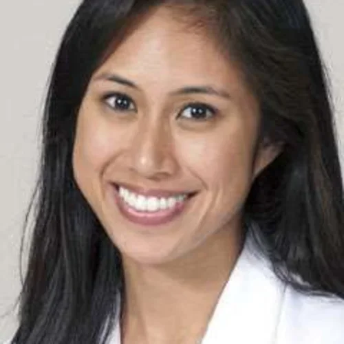 Headshot of Marielle Bolano smiling with a beige background