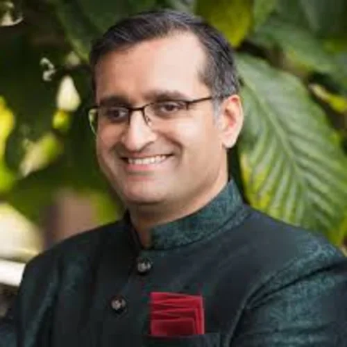 Headshot of Sitaram Vangala smiling and wearing a black suit 