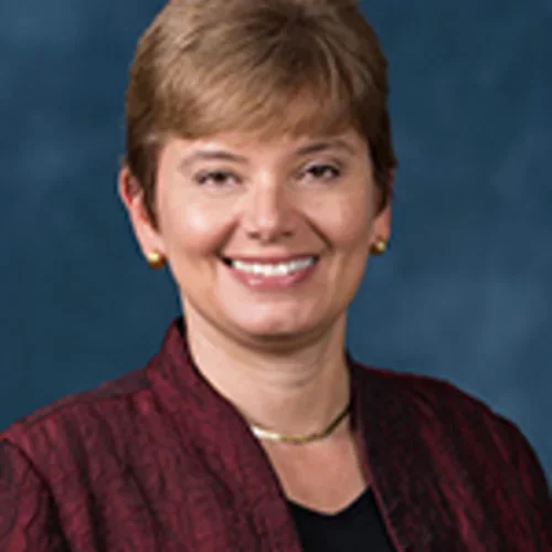 Headshot of Eve Kerr with a dark blue background
