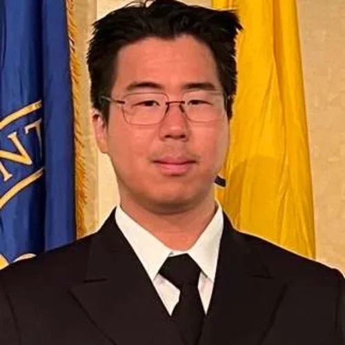 Headshot of Noah Kojima smiling and wearing glasses