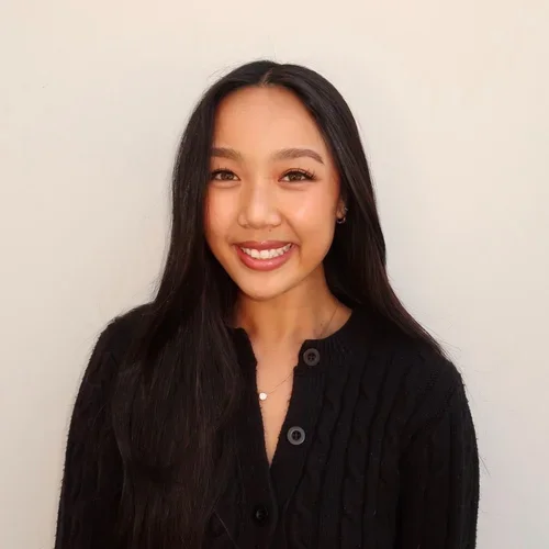 Headshot of Katelyn Nguyen smiling with a beige background