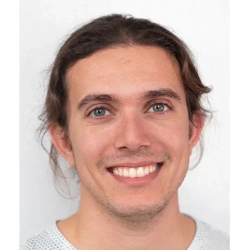 Headshot of Panayiotis Petousis smiling with a white background
