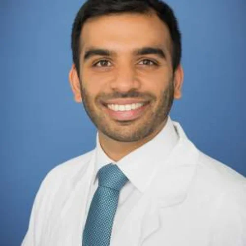 Headshot of Arpan Patel smiling with a light blue background