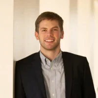 Headshot of Graham Treasure smiling and wearing a suit