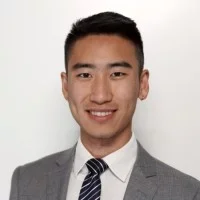 Headshot of Frank Zhou smiling and wearing a suit