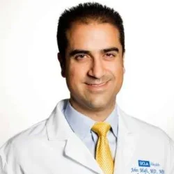 Headshot of John Mafi smiling with a white background