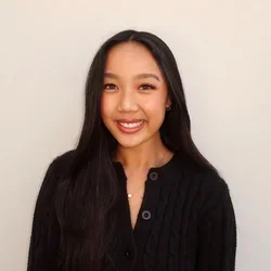 Headshot of Katelyn Nguyen smiling with a beige background